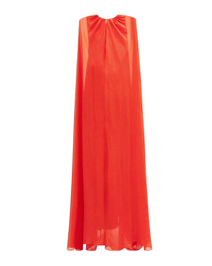 The back of a kaftan style dress in coral color featuring an overlapped cape-like sleeves.