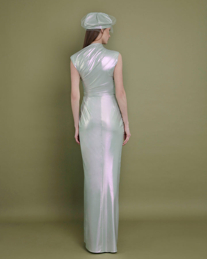 The back of an asymmetrical neckline evening dress in metallic green latex fabric, with draping details on the waist.