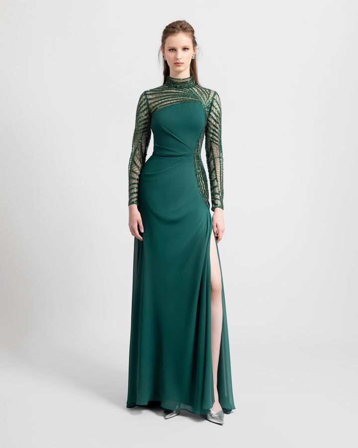 A slim-cut crepe green evening dress featuring see-through and embroidered sleeves and back with an open slit on the side.