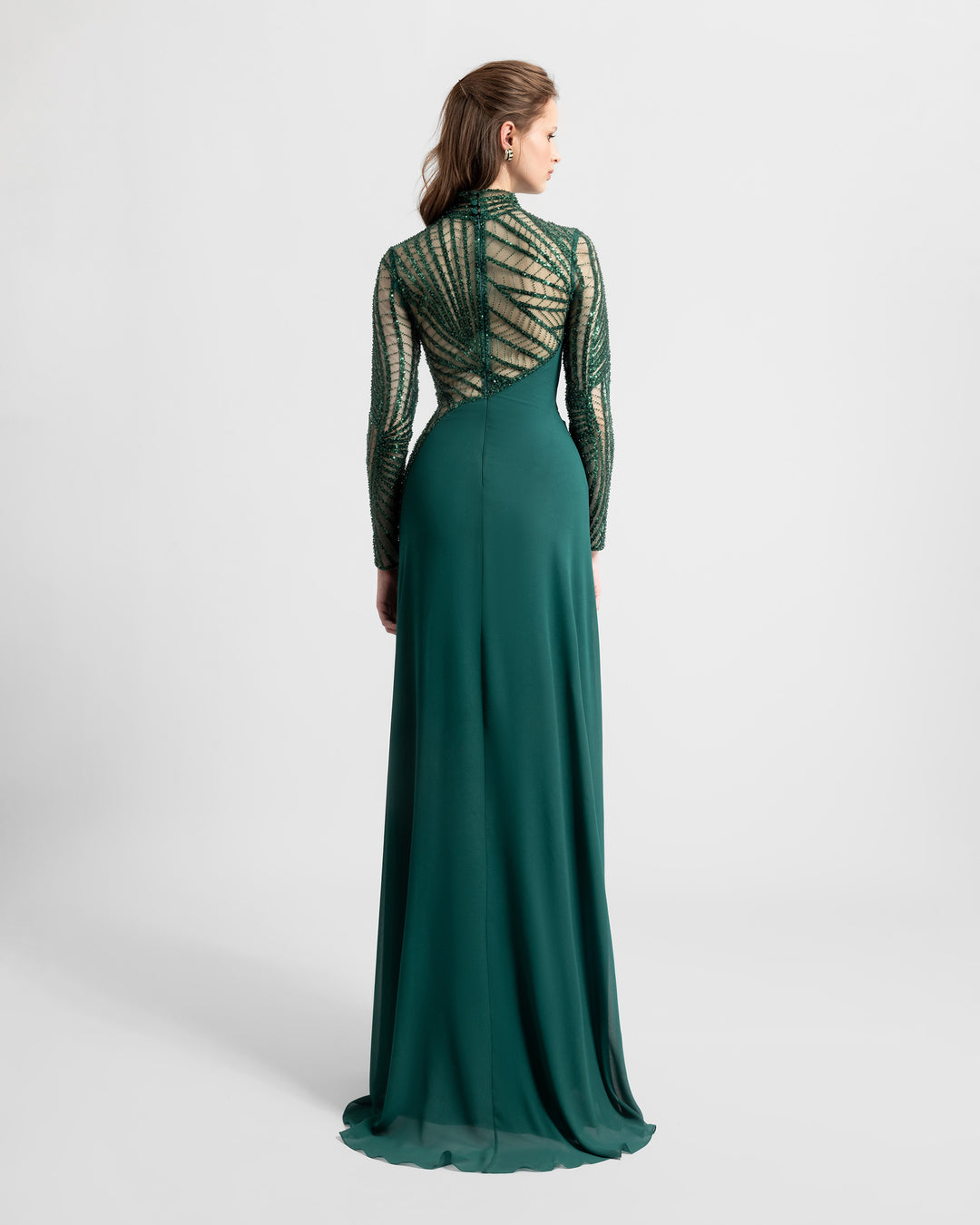 The back of a slim-cut crepe green evening dress featuring see-through and embroidered sleeves and back.