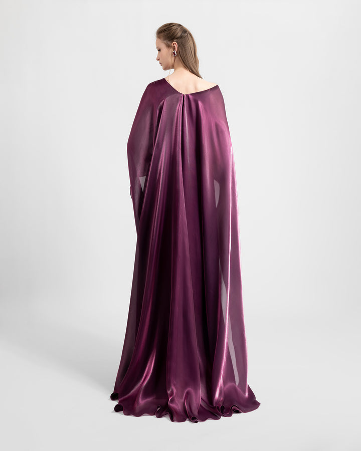 The back of a wide cut neckline and cape-like sleeves flared soft lame organza evening dress in burgundy color.