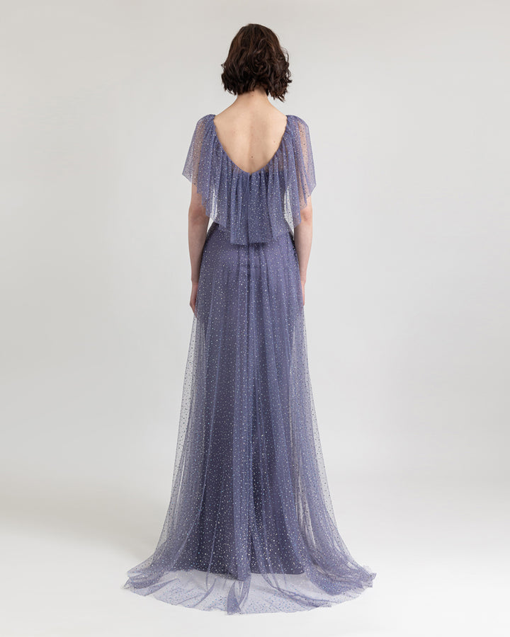 The back of a flared lilac tulle evening dress with draping details on the neckline, and slightly open back.