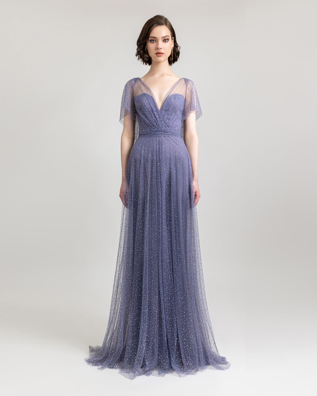 A V-cut neckline flared lilac evening dress with draping details on the waist, and short sleeves.