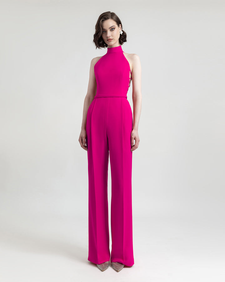 A halter-cut neckline fuchsia jumpsuit with side cut-out details and flared cut pants.