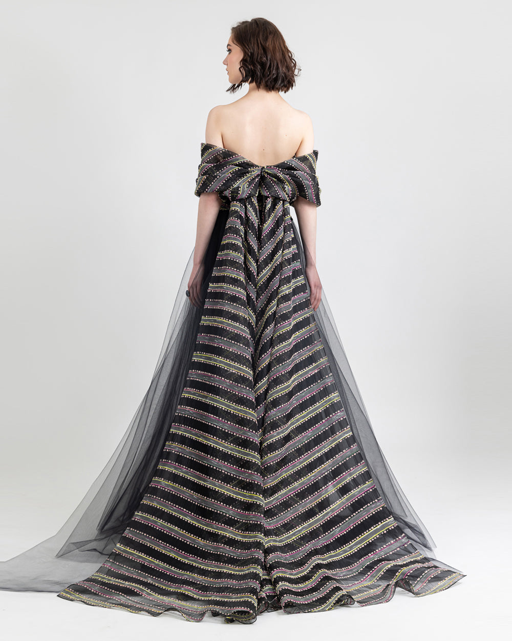 The back of an evening dress featuring a bow like sleeves design with a train.