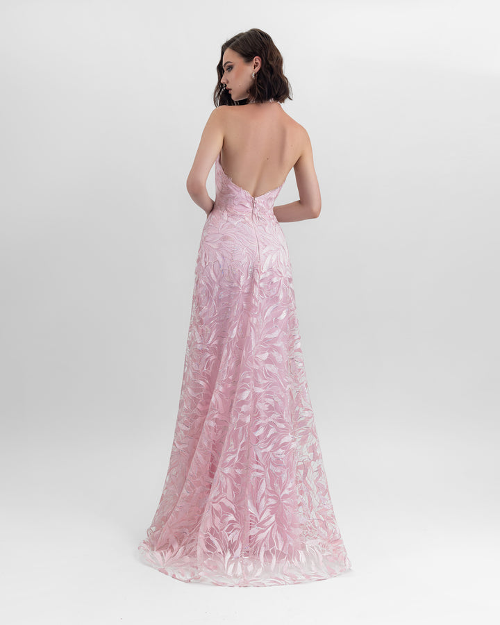 A flared cut embroidered fabric long pink dress with an open back design.