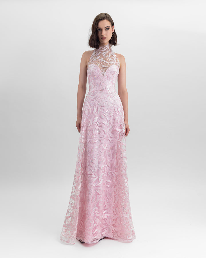 A flared cut embroidered fabric long pink dress with an overlayed halter neckline.