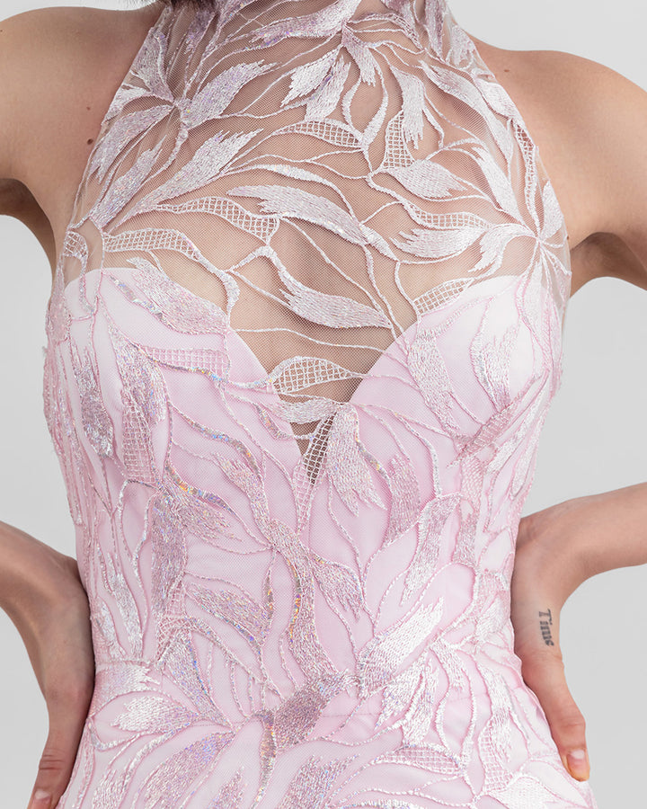 A close-up of a heart shaped pink dress overlayed with an halter neck embroidered fabric.