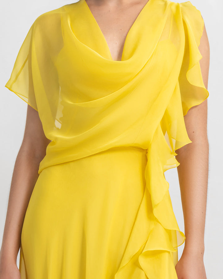 A close-up of an asymmetrical flared chiffon yellow dress with draping and ruffled details.