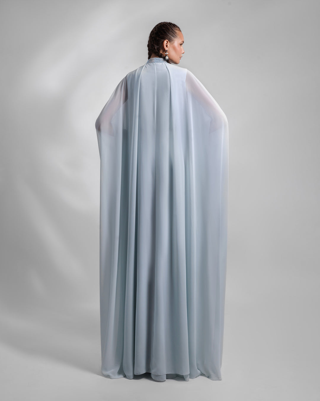 The back of long kaftan style loose chiffon blue evening dress.