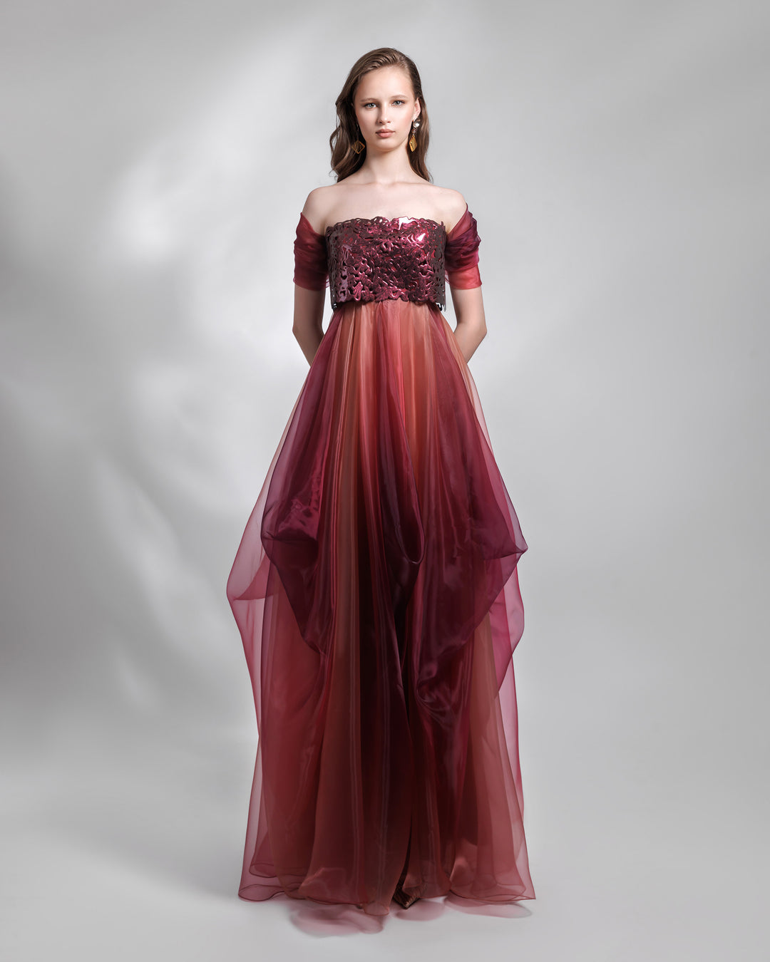 A strapless organza blush aubergine dress, with laser cut intricate bodice and draping details.