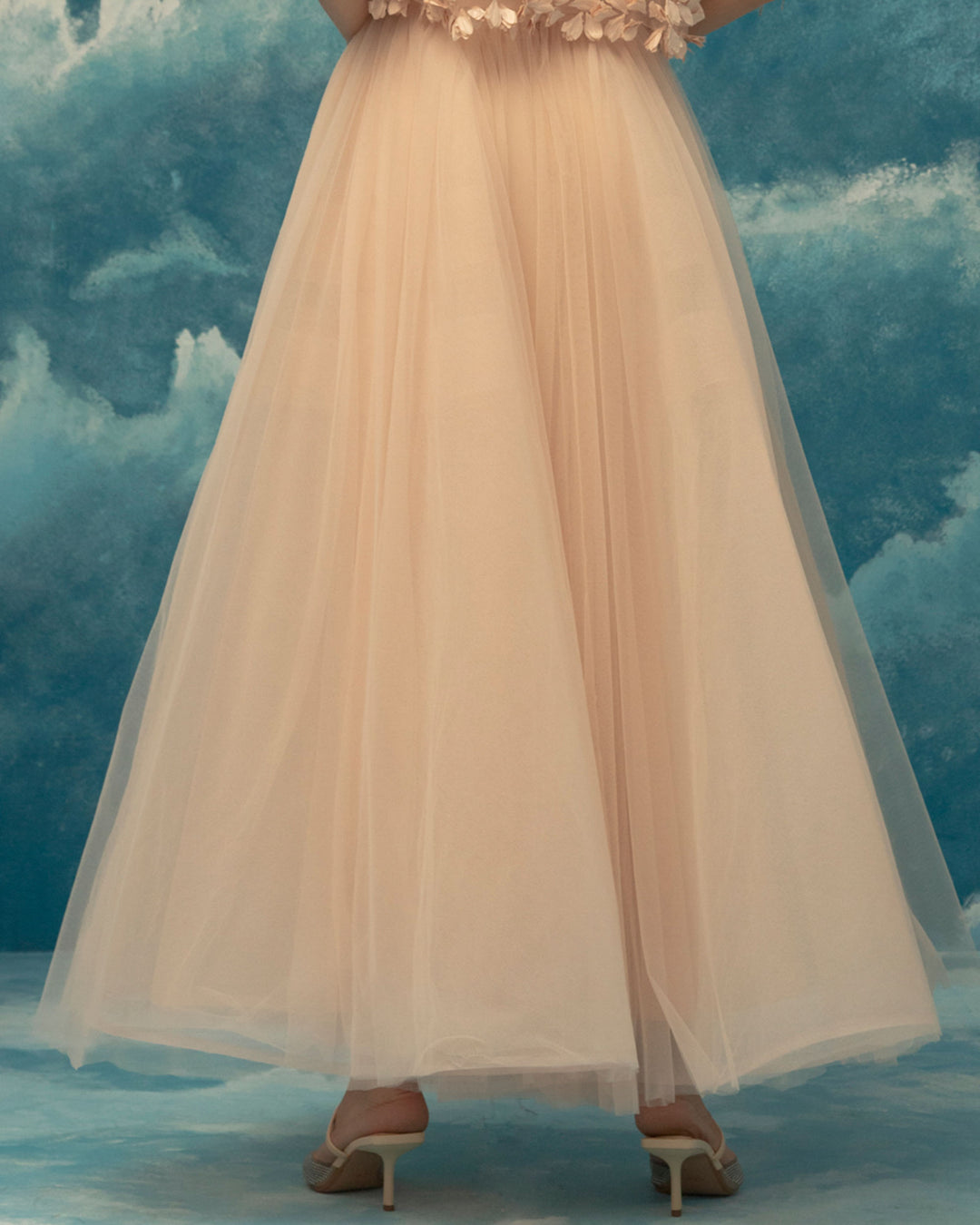 The back of a pink A-cut tulle midi skirt.