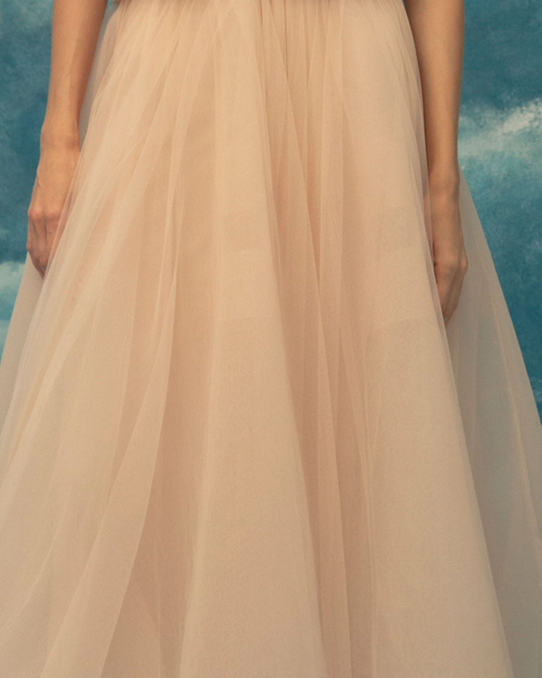 A close-up of a pink A-cut tulle midi skirt.