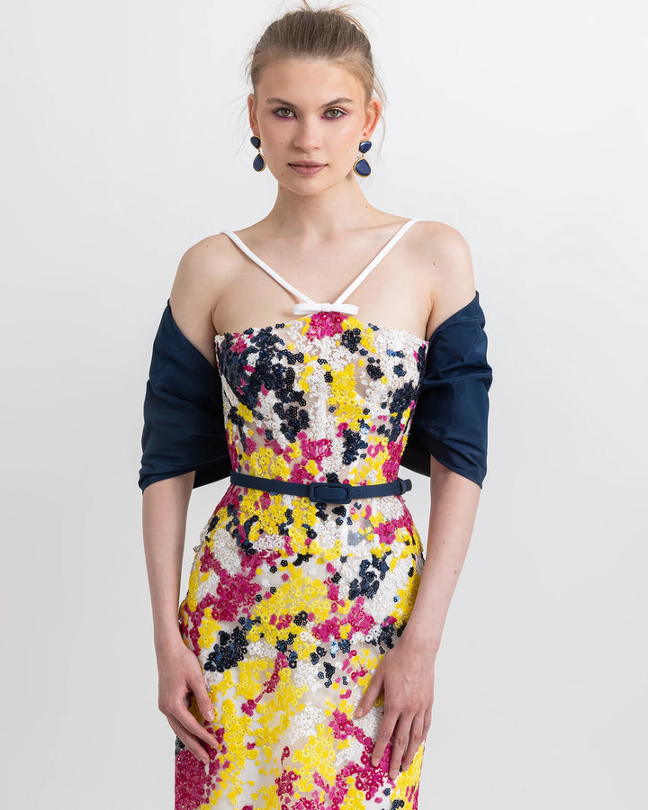 A close-up of a sequined evening wear set featuring a multicolor corset top paired with a matching flared skirt, a belt, and a bolero, both in navy color.