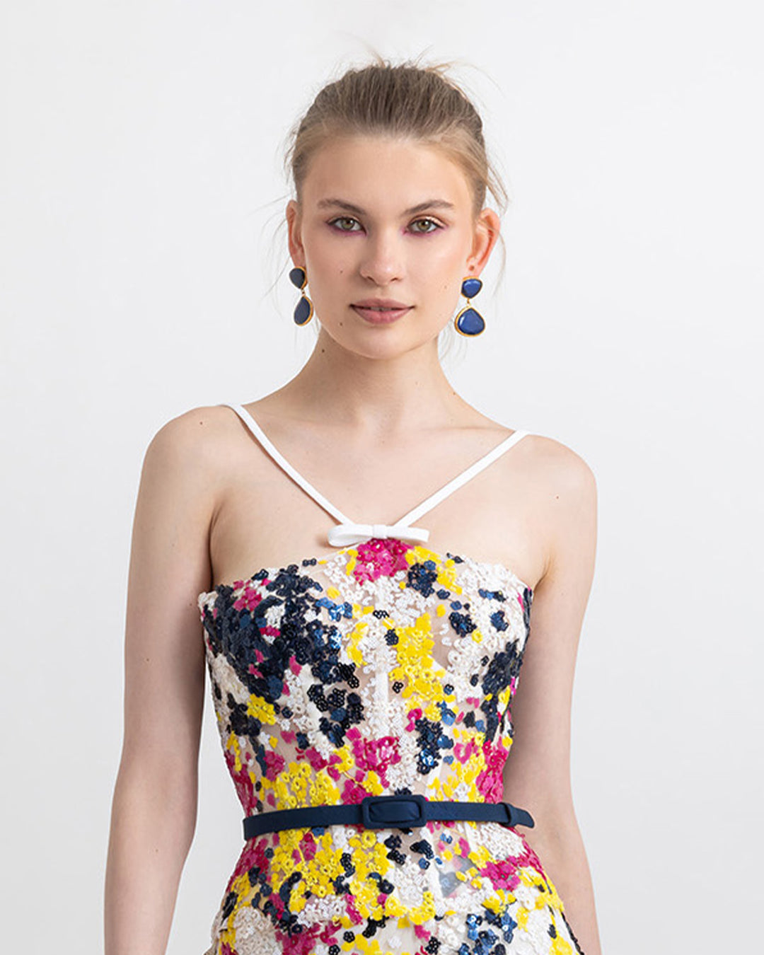 A multicolor sequins corset paired with a navy detachable belt.