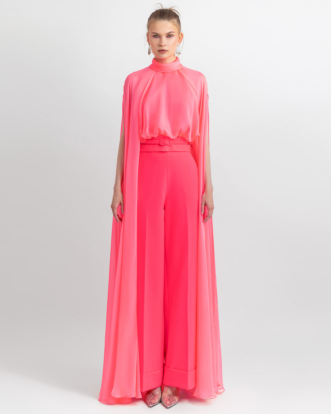 An elegant outfit featuring a high-neckline pink top with long sleeves, paired with straight-cut crepe pants and a detachable belt.