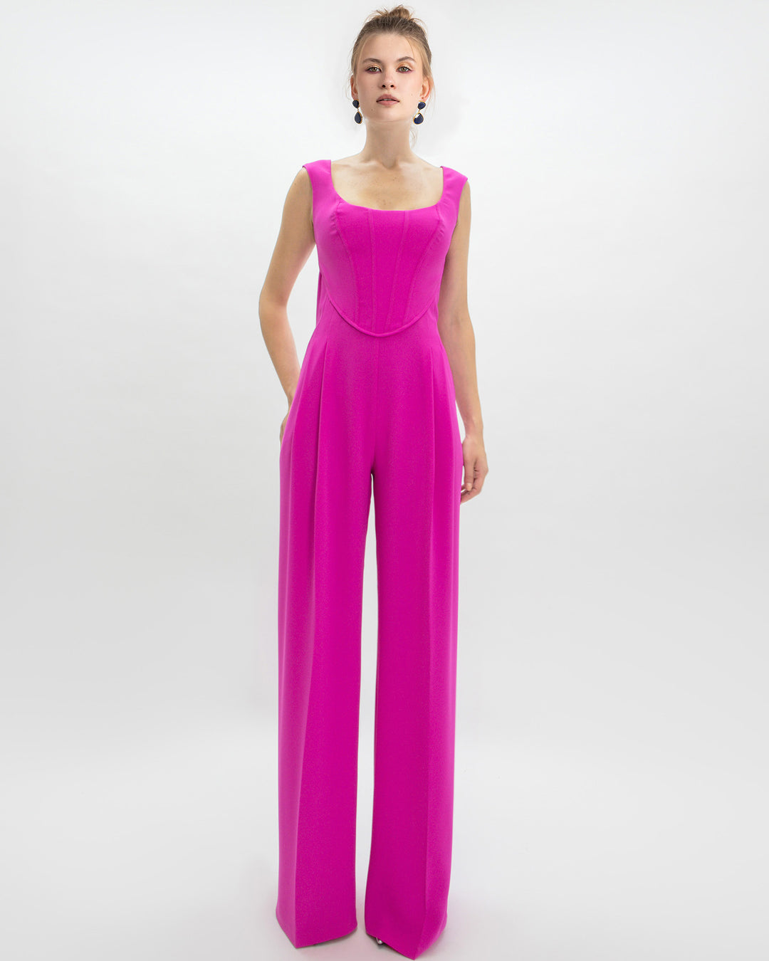 An evening wear look featuring a corset jumpsuit in fuchsia color.