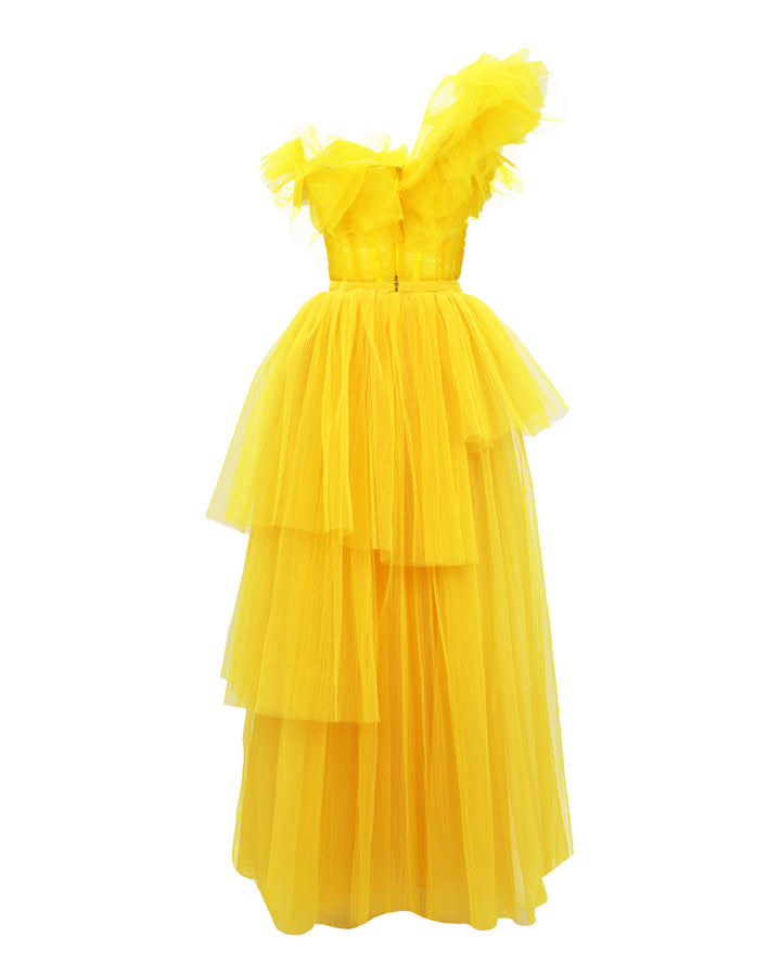 The back of a one-shoulder yellow ruffled corset tulle dress with fully pleated wide skirt.