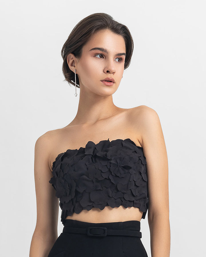 A strapless black cropped-top with laser cut details.