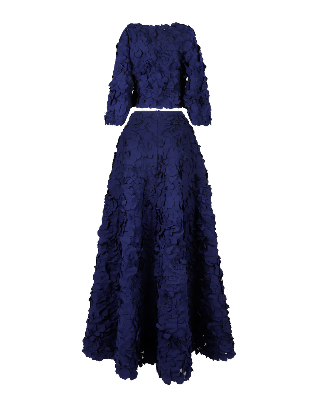 The back of an evening wear featuring a straight-cut laser-cut navy blue top with open-sleeve details, paired with a wide asymmetrical hemline laser-cut navy blue skirt and a detachable belt.