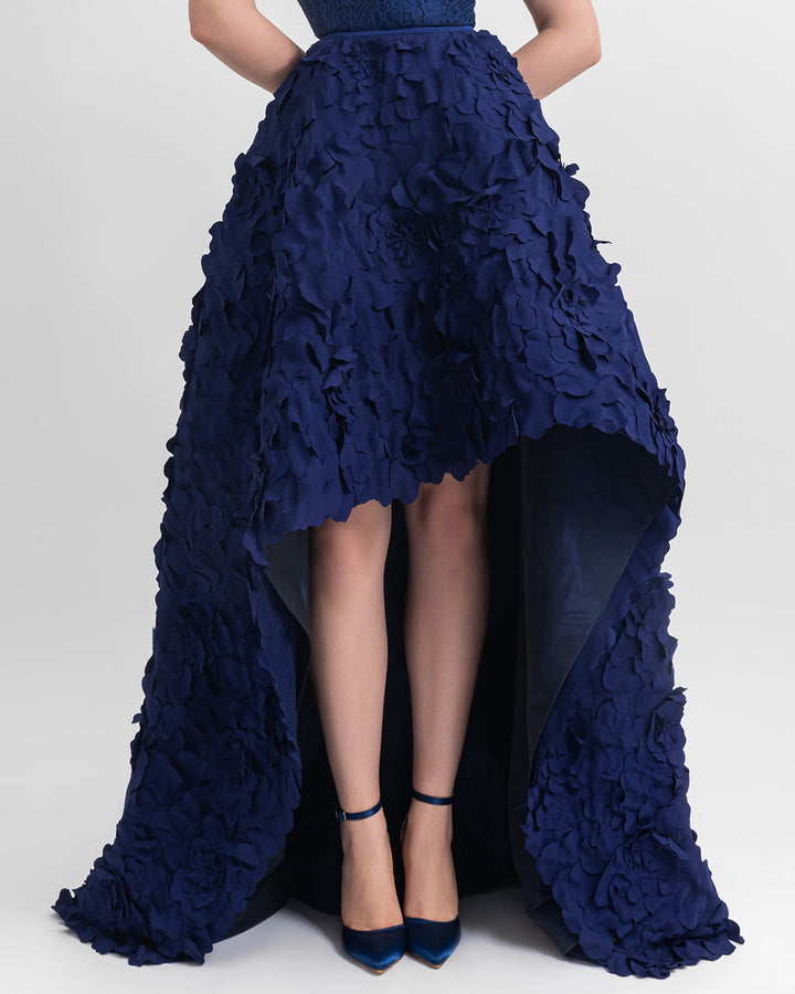 A wide asymmetrical hemline laser-cut navy blue skirt.