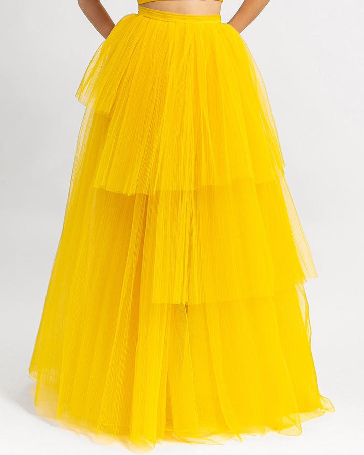 A fully pleated wide tulle yellow skirt.