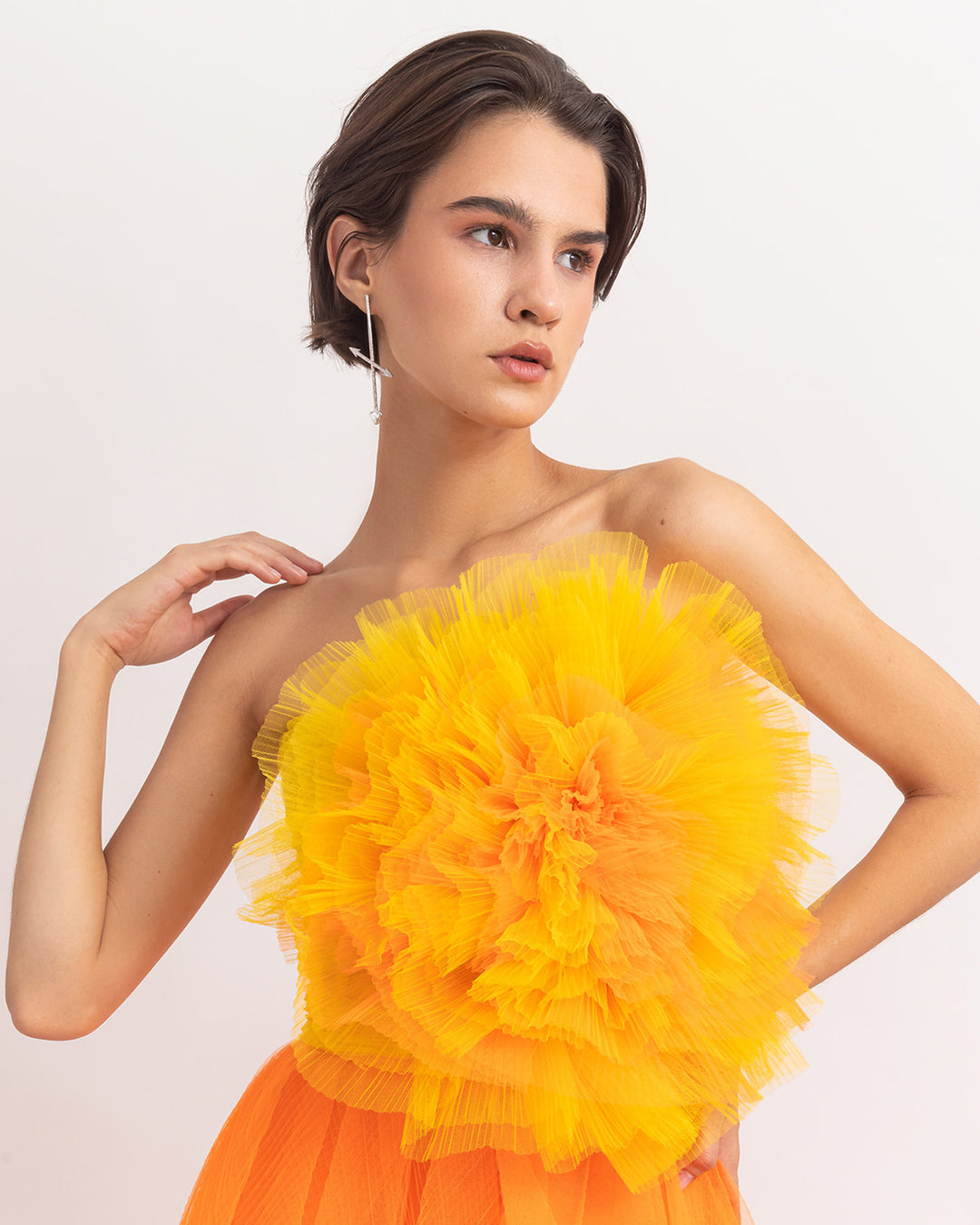 A flower draped bicolor yellow and orange tulle corset.