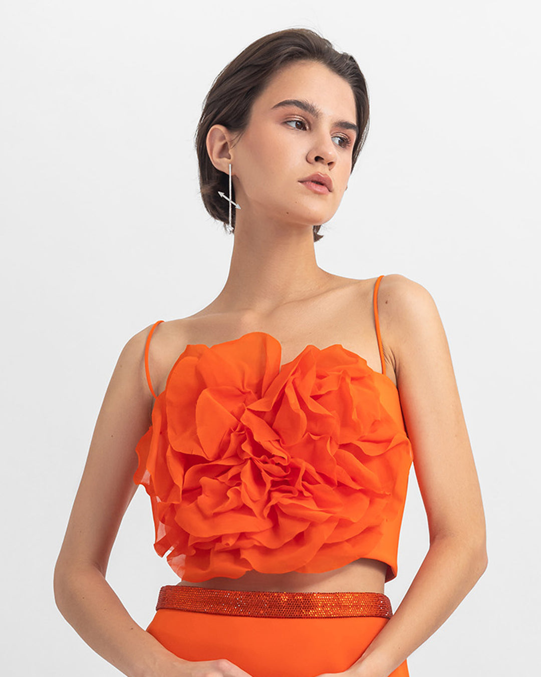 A chiffon flower draped orange cropped top.