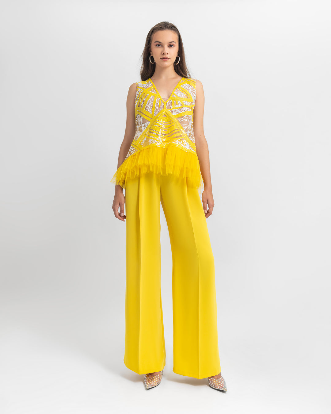 An occasion wear set featuring a straight cut sequin top with tulle details paired with a yellow crepe pants.