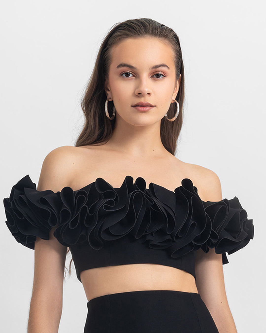 An off-shoulders ruffled crepe black crop top.