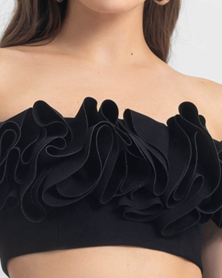 A close-up of an off-shoulders ruffled crepe black crop top.