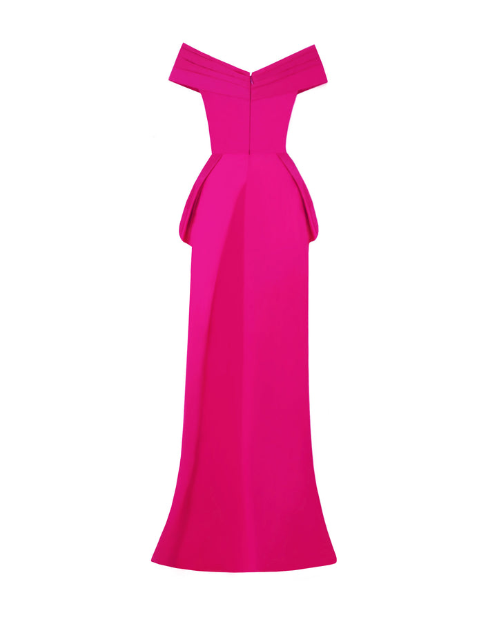 The back of an evening wear fuchsia set featuring an off-shoulder draped taffeta top with back floor length tail. 