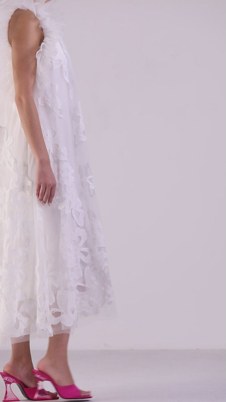 An A-line cut white midi dress in fully embroidered fabric, featuring ruffled shoulders.